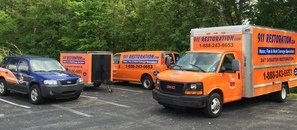 Water Damage Restoration Trucks Going To Job Site